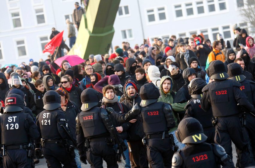 Policemen stand in front of 'Blockupy' anti-capitalist protesters near the ECB building before the official opening of its new headquarters in Frankfurt